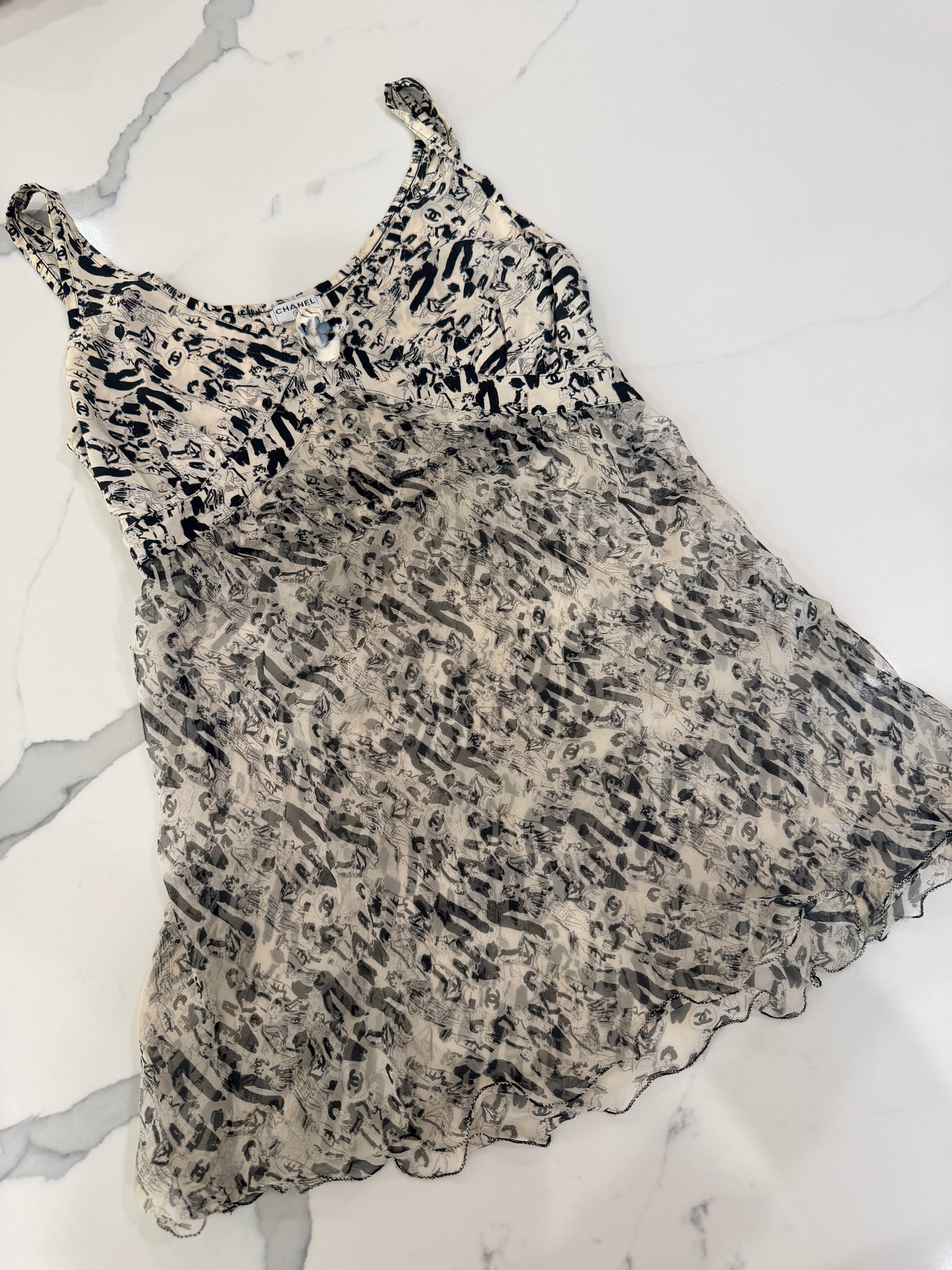 Chanel vintage 03P CC logo tunic top features a white and black silk print with a ruffled frill