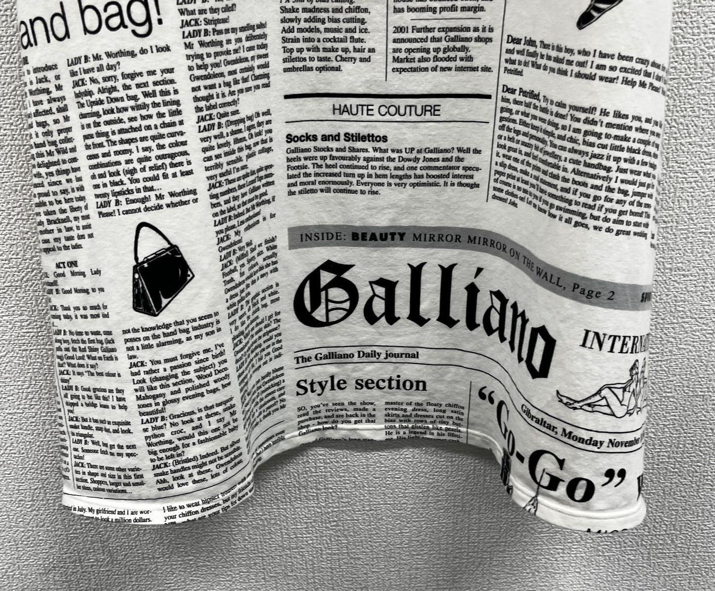 Newspaper/gazette/newspaper print slip dress, an iconic John Galliano design.