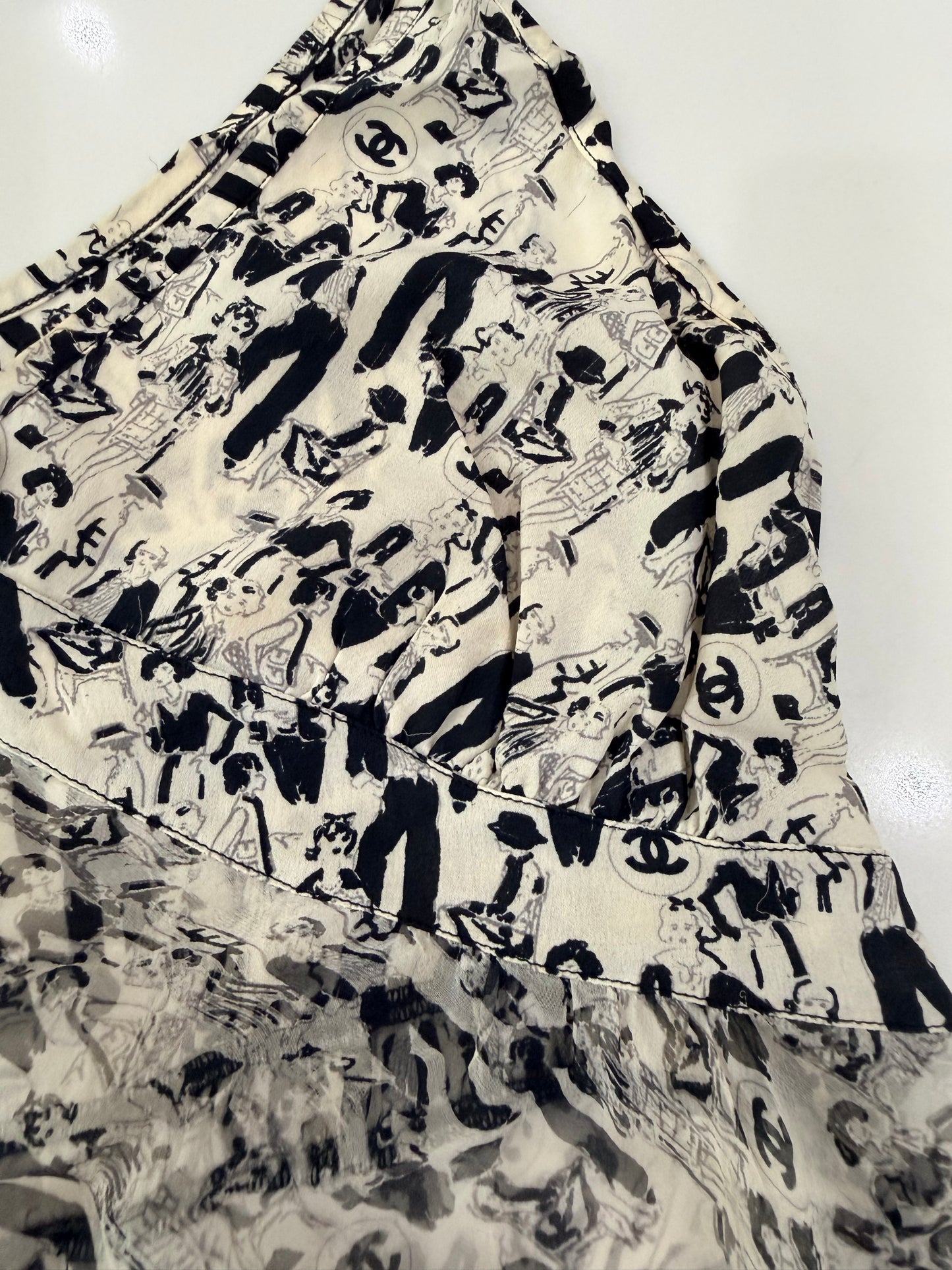 Chanel vintage 03P CC logo tunic top features a white and black silk print with a ruffled frill