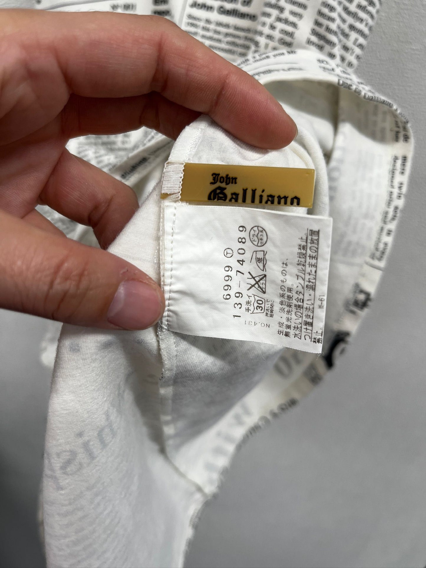 Newspaper/gazette/newspaper print slip dress, an iconic John Galliano design.