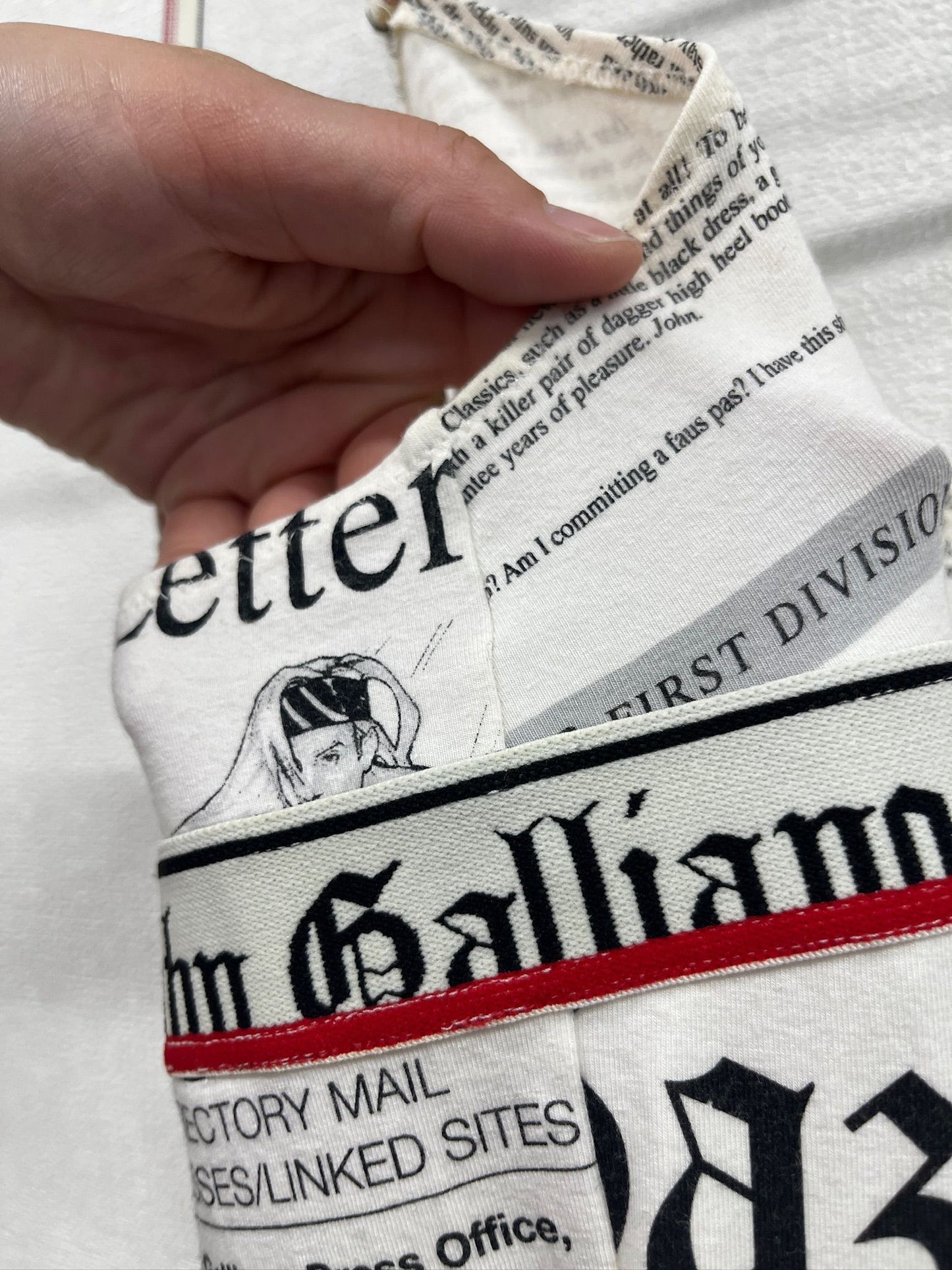 Newspaper/gazette/newspaper print slip dress, an iconic John Galliano design.