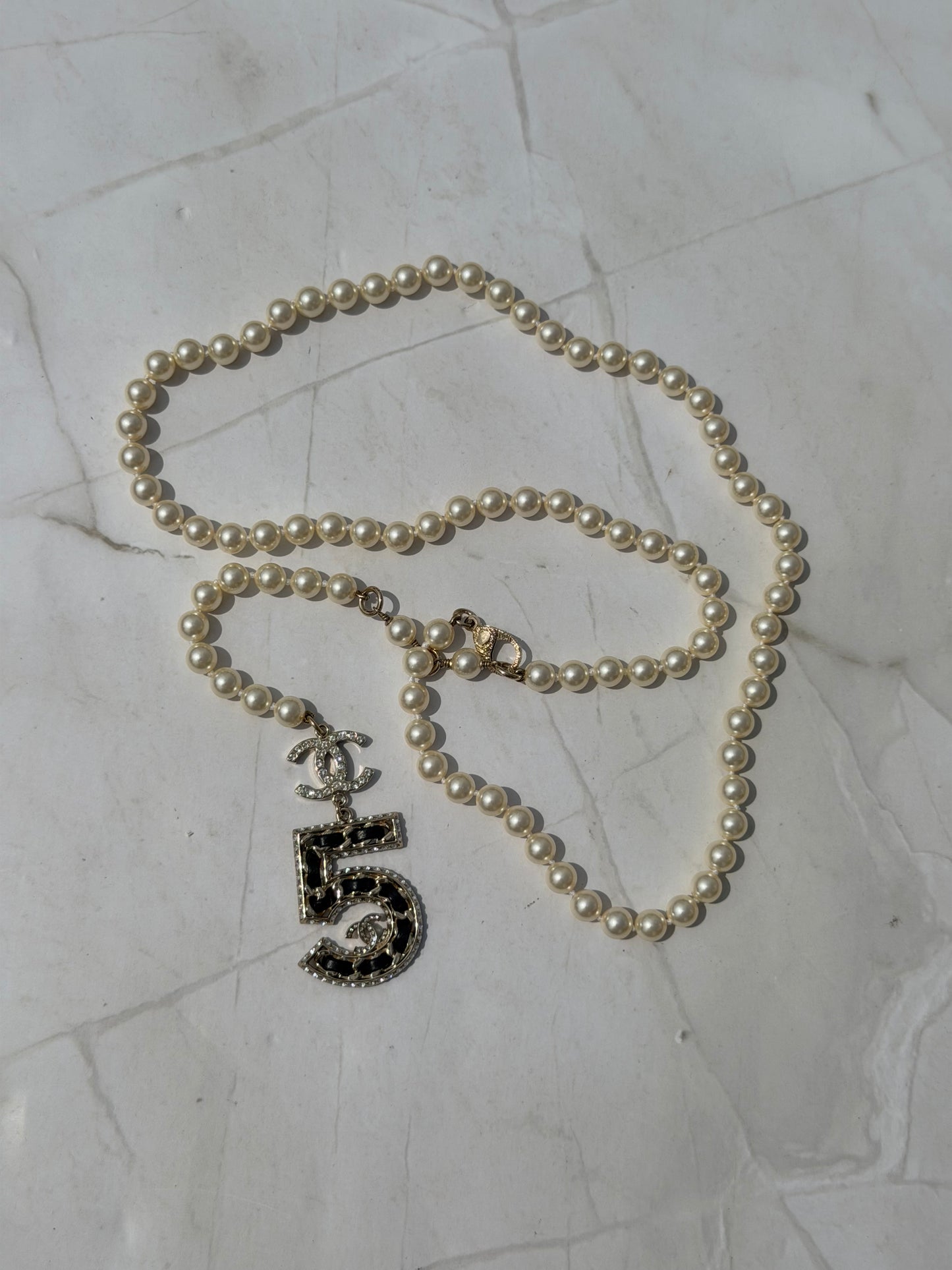 Iconic Chanel Pearl Necklace or Belt featuring the No 5 strass and leather Charm