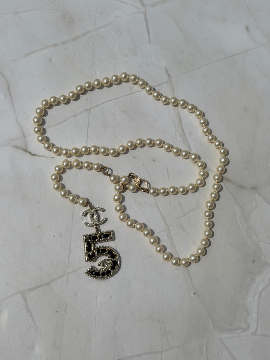 Iconic Chanel Pearl Necklace or Belt featuring the No 5 strass and leather Charm