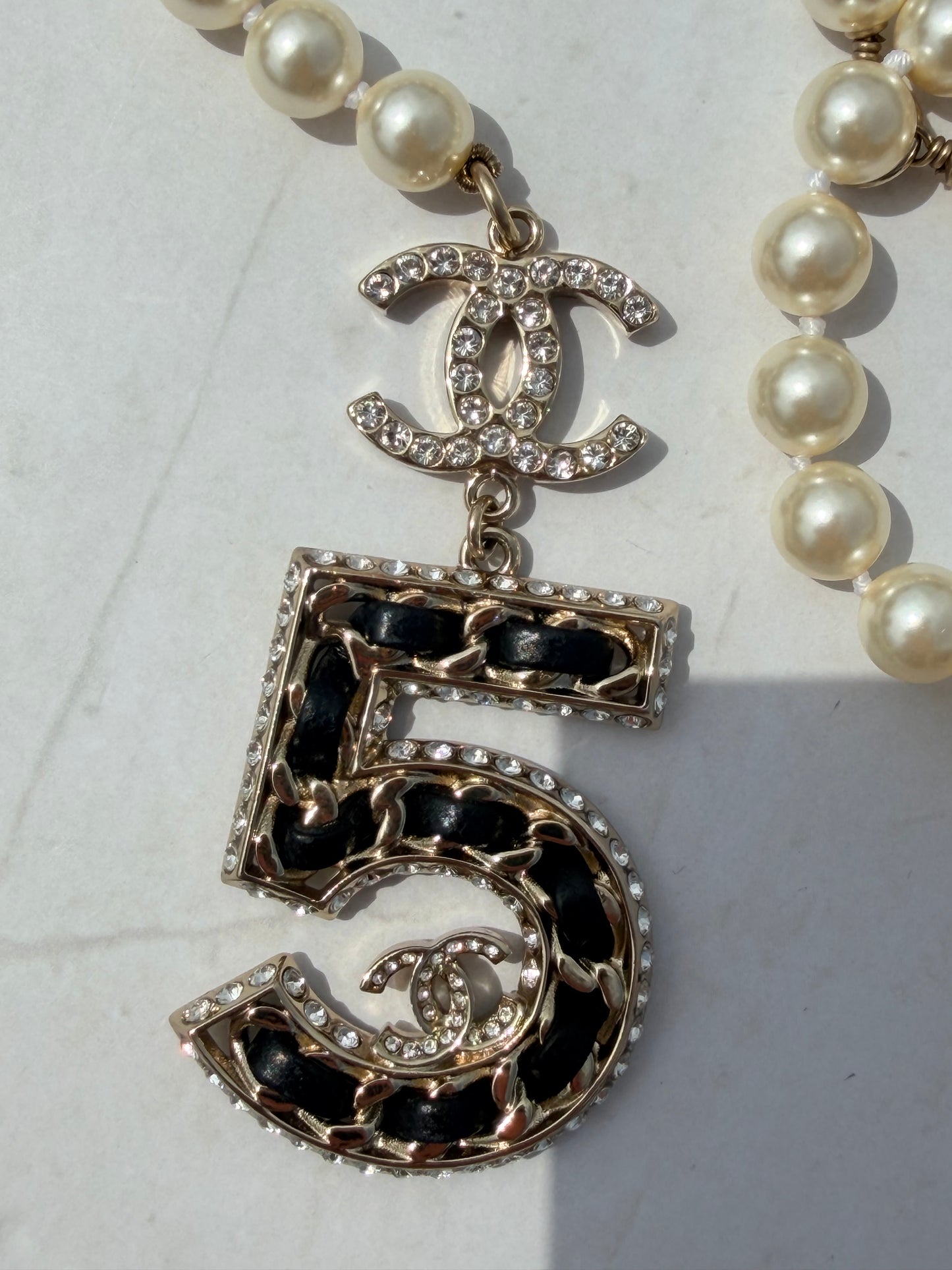 Iconic Chanel Pearl Necklace or Belt featuring the No 5 strass and leather Charm