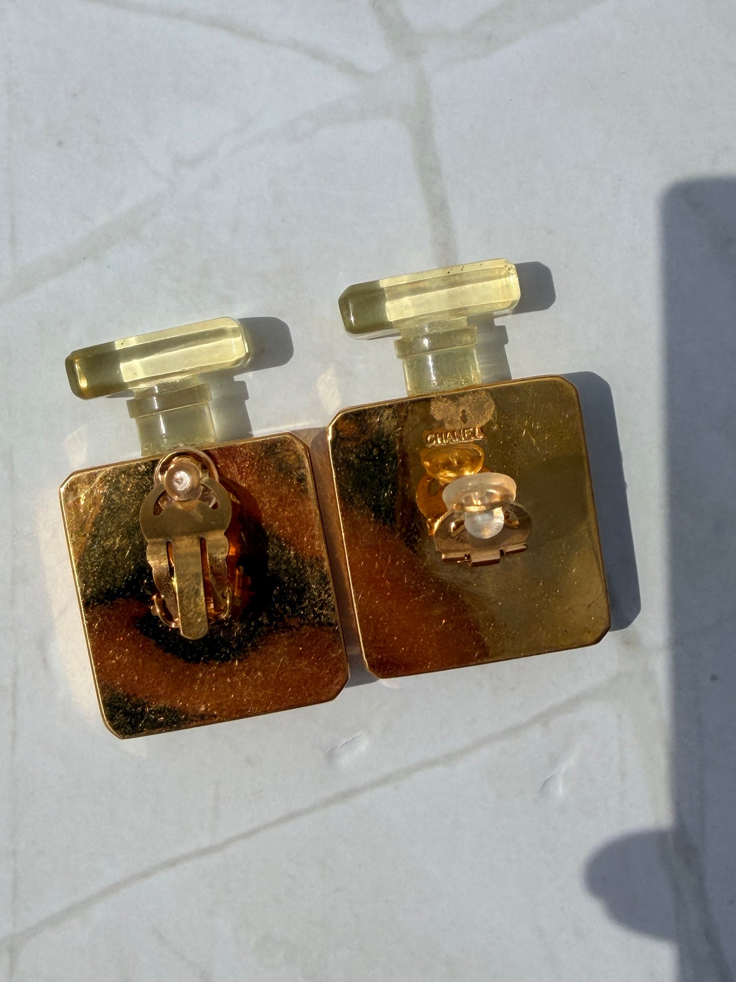 Rare Vintage CHANEL golden perfume bottle clip-on earrings with embossed logo