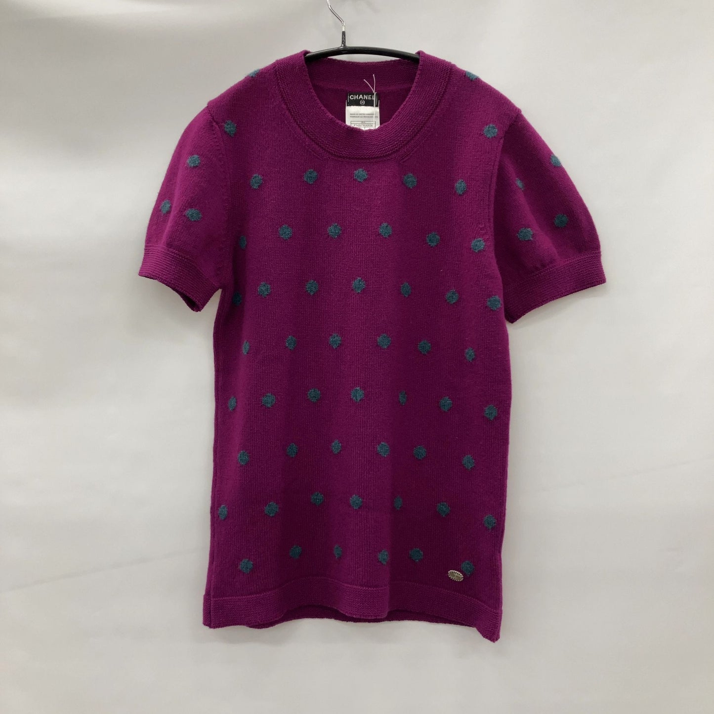 Chanel Short sleeve sweater with polkadots and sweater emblem on back.