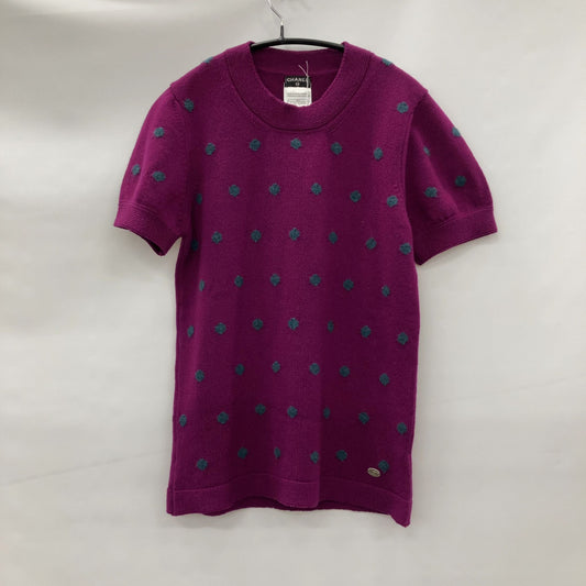 Chanel Short sleeve sweater with polkadots and sweater emblem on back.
