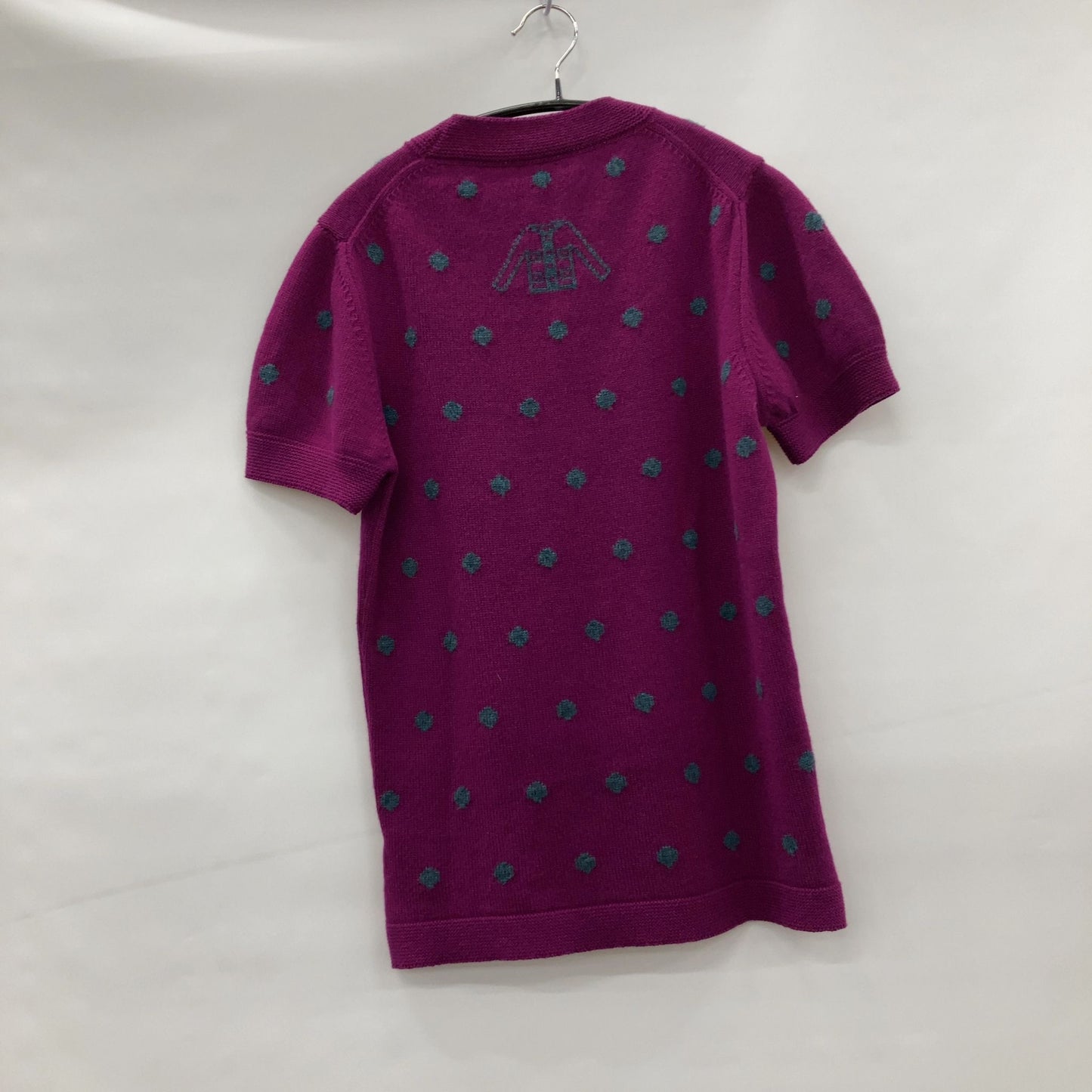 Chanel Short sleeve sweater with polkadots and sweater emblem on back.