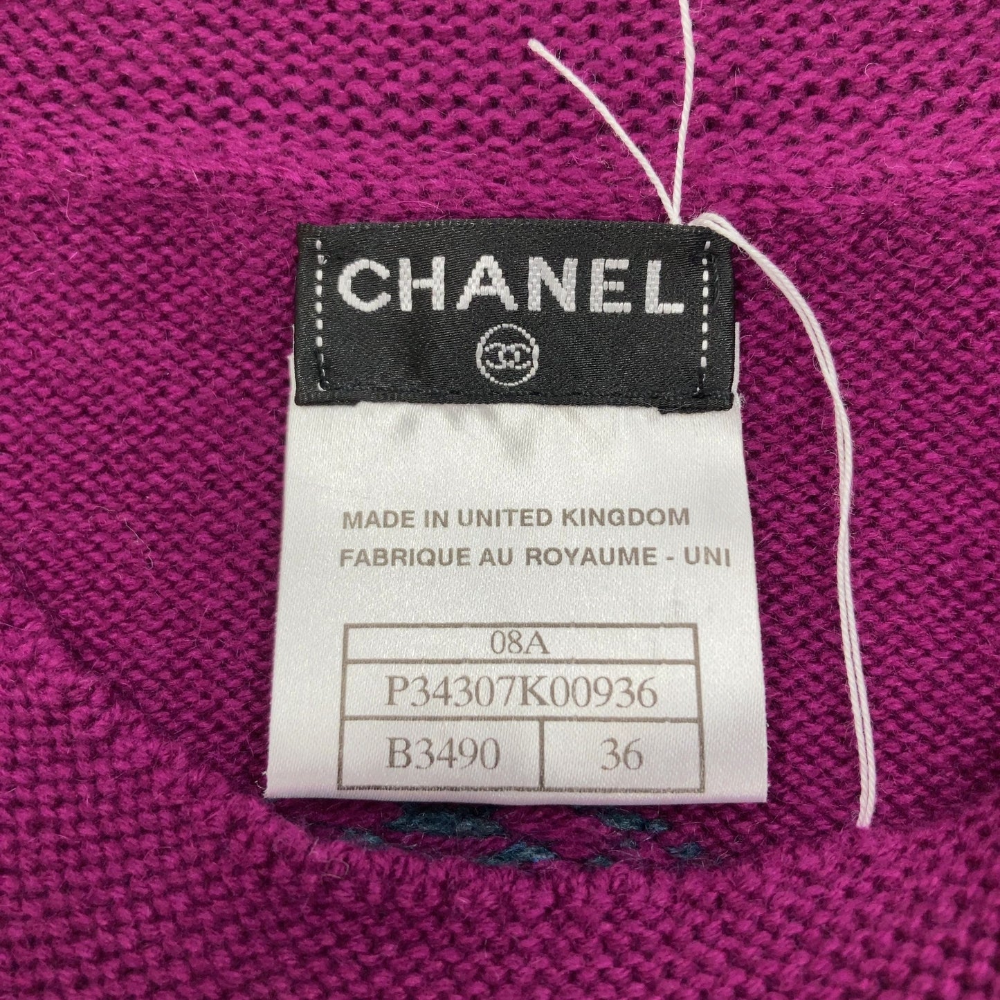 Chanel Short sleeve sweater with polkadots and sweater emblem on back.
